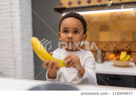 Cute little boy with banana in his hands Cute little boy with banana in his hands 118949657