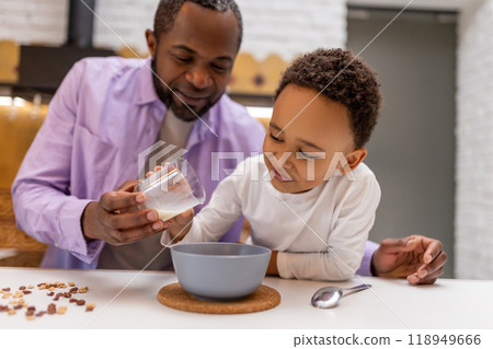 Father and kids having breakfast together in the kitchen Father and kids having breakfast together in the kitchen 118949666