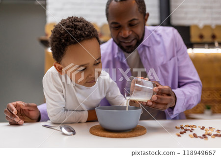 Father and kids having breakfast together in the kitchen 118949667