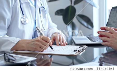 Doctor woman consulting patient in clinic office while both are sitting at the glass desk. Medicine concept 118950161