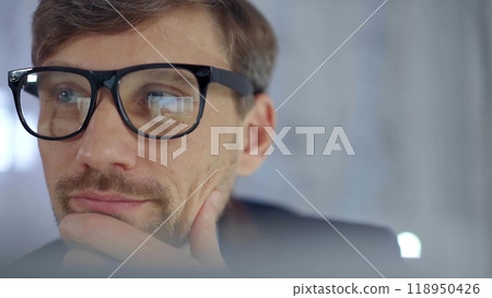 Businessman with glasses looking intently obscured partially by a translucent surface of laptop. Business concept 118950426