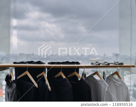 Black and white clothes hanging at the balcony in the cloudy day. Black and white clothes hanging at the balcony in the cloudy day. 118950516