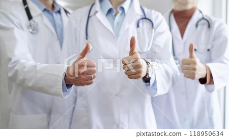 Group of doctors are are standing and showing thumbs up in hospital corridor. Medicine excellent service 118950634