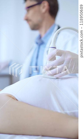 Doctor man is using ultrasound machine to examine internal organs of a patient woman. Female mammary gland health, cancer prevention. Medicine 118950689