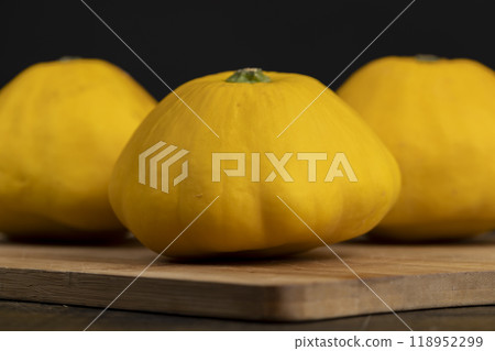 yellow ripe pumpkins on the table in close-up 118952299