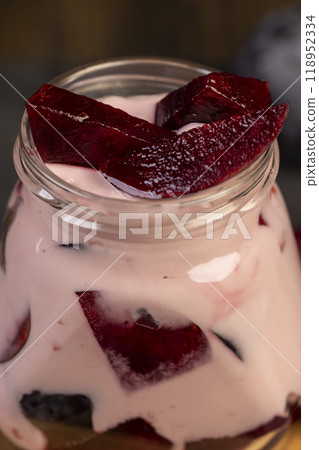 plum yogurt with slices and whole fruits on the table 118952334