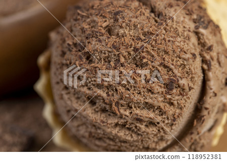 chocolate ice cream in a cone on a board chocolate ice cream in a cone on a board 118952381