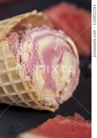 watermelon red ice cream with slices of ripe red watermelon, red watermelon and ice cream on a black slate board close-up 118952391