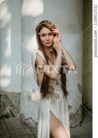 Two beautiful girls, sisters Lilith and Eva, pose in rocking dresses against the background of columns. 118952532