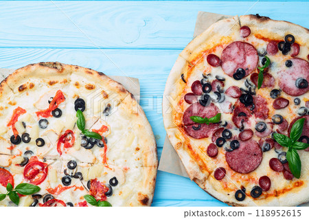 2 pizza with mozzarella cheese , salami sausages , olives , chicken , pineapple and tomatoes 2 pizza with mozzarella cheese , salami sausages , olives , chicken , pineapple and tomatoes 118952615