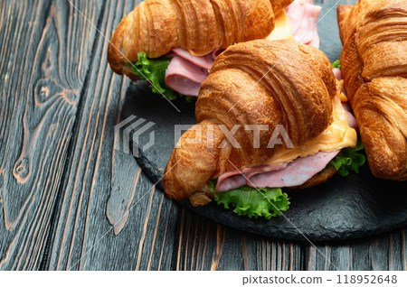 Croissant sandwich with salad ham and cheese . Top view Croissant sandwich with salad ham and cheese . Top view 118952648