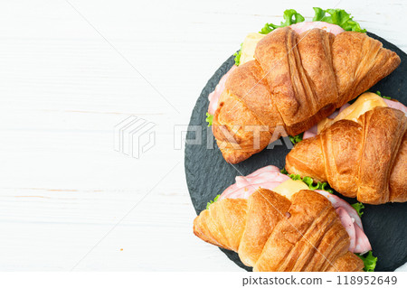 Croissant sandwich with salad ham and cheese . Top view Croissant sandwich with salad ham and cheese . Top view 118952649