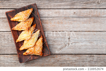 Homemade triangle puff pastry with meat on rustic background . Samosa Homemade triangle puff pastry with meat on rustic background . Samosa 118952674
