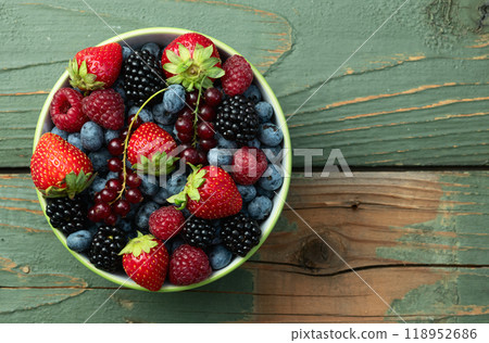 Mix of ripe colorful berries in bowl photography . Blueberry , strawberry , raspberry , blackberry and red currant . Top view Mix of ripe colorful berries in bowl photography . Blueberry , strawberry , raspberry , blackberry and red currant . Top view 118952686