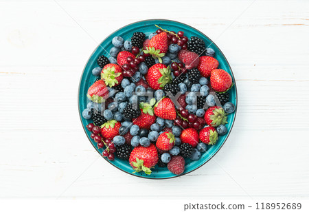 Mix of ripe colorful berries in bowl photography . Blueberry , strawberry , raspberry , blackberry and red currant . Top view 118952689