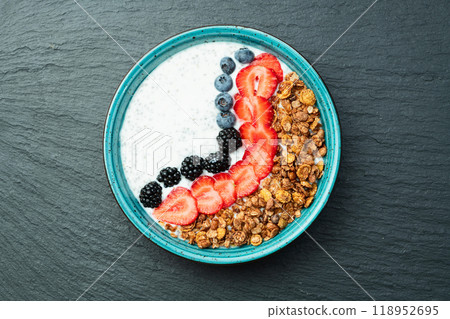 Healthy breakfast . Yogurt with berries ( strawberry , raspberry , blueberry , blackberry ) , granola and chia seeds . Top view 118952695