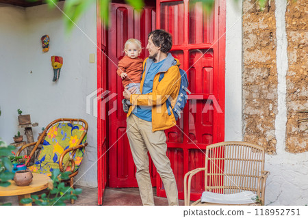 Father and his son tourists in a colonial house in San Cristobal de las Casas, Mexico. Cultural exploration, architecture, and travel experience concept 118952751