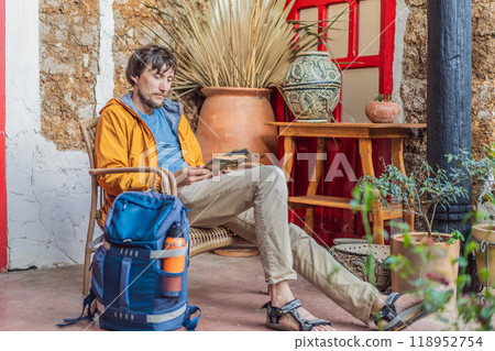 Male tourist in a colonial house in San Cristobal de las Casas, Mexico. Cultural exploration, architecture, and travel experience concept Male tourist in a colonial house in San Cristobal de las Casas, Mexico. Cultural exploration, architecture, and travel experience concept 118952754