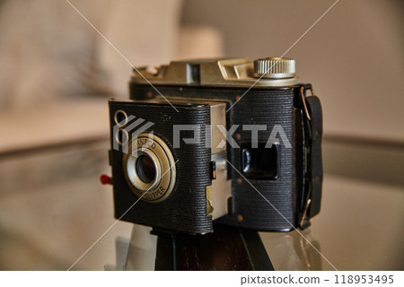 Vintage Ansco Film Camera on Reflective Surface, Eye-Level Angle Vintage Ansco Film Camera on Reflective Surface, Eye-Level Angle 118953495
