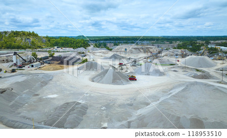Aerial View of Expansive Quarry with Gravel Piles and Machinery 118953510