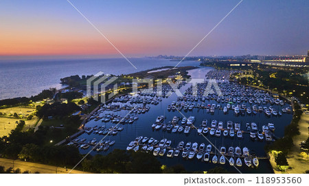 Burnham Harbor on Lake Michigan boats at night with sunset lighting and city lights, Chicago aerial Burnham Harbor on Lake Michigan boats at night with sunset lighting and city lights, Chicago aerial 118953560