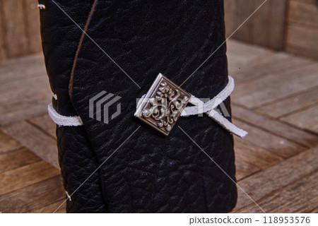 Vintage Leather Clasp Detail on Wooden Texture 118953576