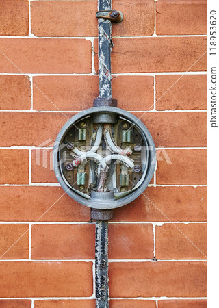 Aged Electrical Junction Box on Brick Wall, Eye-Level View 118953620