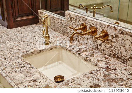 Elegant Granite Bathroom Sink with Brass Faucets 118953640
