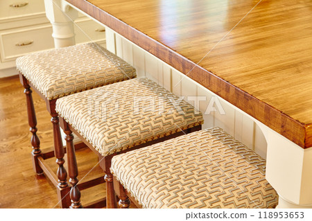 Elegant Wooden Bar Stools at Kitchen Island Interior Elegant Wooden Bar Stools at Kitchen Island Interior 118953653