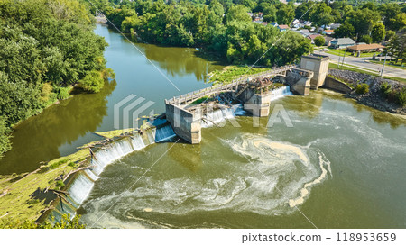 Maumee River Dam swirling water with waterfalls chocked by tree logs aerial of river Fort Wayne, IN Maumee River Dam swirling water with waterfalls chocked by tree logs aerial of river Fort Wayne, IN 118953659