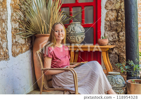 Female tourist in a colonial house in San Cristobal de las Casas, Mexico. Cultural exploration, architecture, and travel experience concept Female tourist in a colonial house in San Cristobal de las Casas, Mexico. Cultural exploration, architecture, and travel experience concept 118954328
