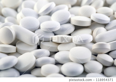 Heap of medicine white pills macro shot 118954371