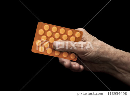 Medicine pills in senior hand over black background Medicine pills in senior hand over black background 118954498