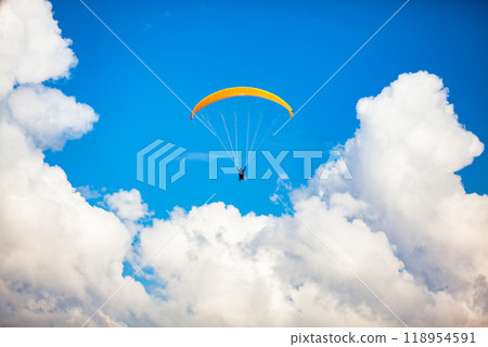 People paragliding over the beautiful mountains of the Antioquia department in Colombia. Tandem Paragliding. Extreme sport concept. 118954591