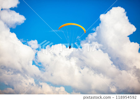 People paragliding over the beautiful mountains of the Antioquia department in Colombia. Tandem Paragliding. Extreme sport concept. People paragliding over the beautiful mountains of the Antioquia department in Colombia. Tandem Paragliding. Extreme sport concept. 118954592