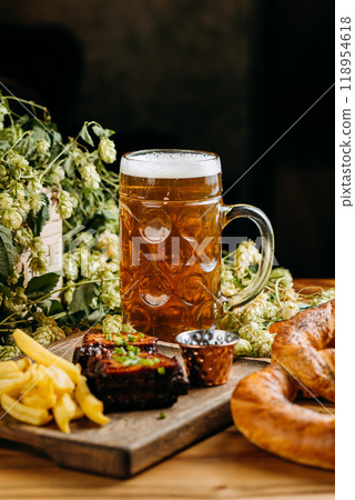 Beer with roasted ribs and French fries, perfect meal for a traditional pub or restaurant setting 118954618