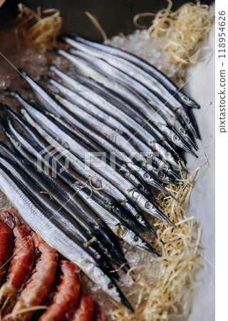 Fresh fish lined up on ice display at seafood market. Perfect for food photography, menus 118954626