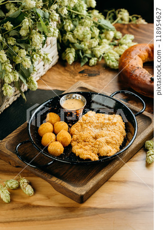 Crispy breaded chicken fillet with golden potato croquettes and creamy dipping sauce 118954627