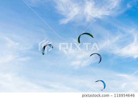 People practicing kitesurfing on the beach of Los Canos de Meca, next to the Trafalgar Lighthouse, Barbate, Cadiz People practicing kitesurfing on the beach of Los Canos de Meca, next to the Trafalgar Lighthouse, Barbate, Cadiz 118954646