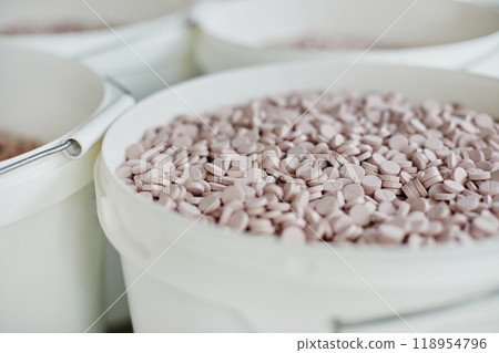 Background shot of big white container with lots of pink pills stored in pharmaceutical factory warehouse, copy space Background shot of big white container with lots of pink pills stored in pharmaceutical factory warehouse, copy space 118954796