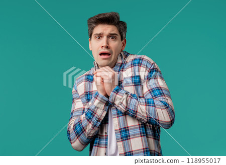 Frightened man afraid of something looks into camera with big eyes full horror Frightened man afraid of something looks into camera with big eyes full horror 118955017