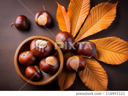 Autumn taste: picking chestnuts and falling leaves 118955121