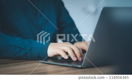 Entrepreneur use laptop working in home office. Man typing on laptop computer keyboard. Business and technology concept of entrepreneur work, work from home, businessman working at home office. Entrepreneur use laptop working in home office. Man typing on laptop computer keyboard. Business and technology concept of entrepreneur work, work from home, businessman working at home office. 118956365