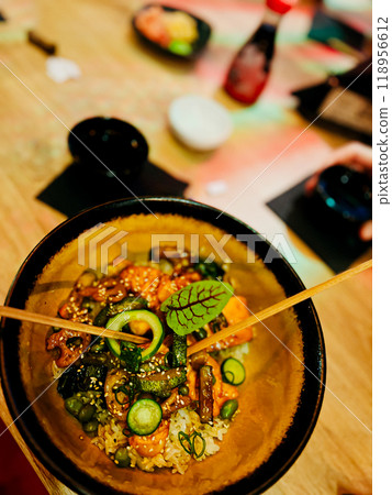 Traditional japanese food in a bowl on a wooden table. Traditional japanese food in a bowl on a wooden table. 118956612