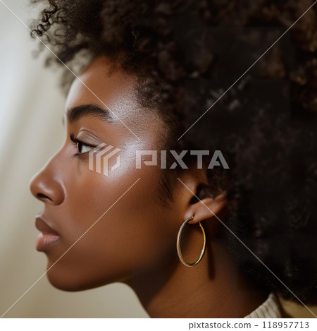 Close up of a woman ear showcasing elegant hoop earrings in soft lighting Close up of a woman ear showcasing elegant hoop earrings in soft lighting 118957713