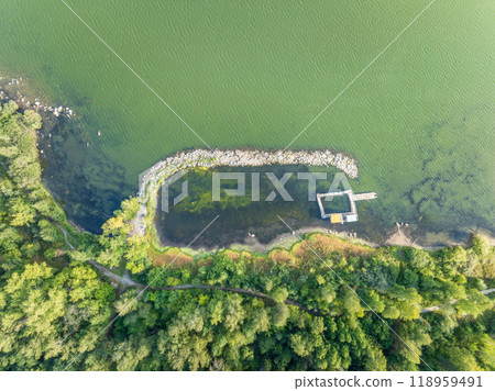 Aerial view of lake or river green shore with forest. Summer season. Aerial view of lake or river green shore with forest. Summer season. 118959491