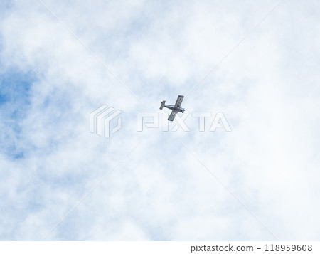 Small ultralight airplane with overhead wing and single propeller flying in sunset sky. Small ultralight airplane with overhead wing and single propeller flying in sunset sky. 118959608