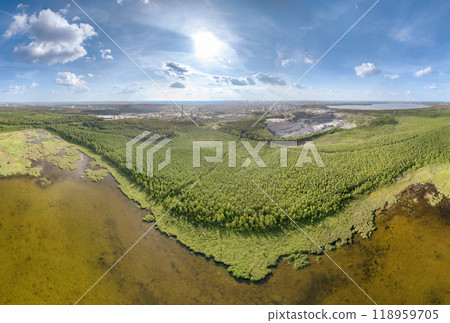 Big lake with green shores in bright sun light and city on horizon, aerial landscape. Recreation concept. Aerial view Big lake with green shores in bright sun light and city on horizon, aerial landscape. Recreation concept. Aerial view 118959705