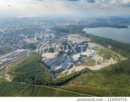 Stone quarry in the forest. Flying over the summer mixed forest during sunset. The surroundings of Yekaterinburg. Ural, Russia, Aerial View Stone quarry in the forest. Flying over the summer mixed forest during sunset. The surroundings of Yekaterinburg. Ural, Russia, Aerial View 118959716