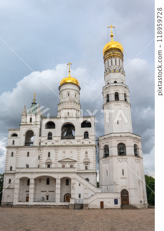 Ivan the Great Bell Tower, with Assumption Belfry on the right in Moscow Kremlin. Blue sky background with sunbeams 118959728